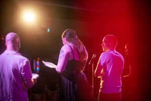 Cast on stage from behind